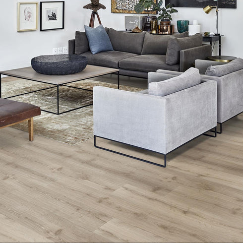 The Kährs Click 6mm Impression in Dovecot, showing off it's deep beige tones in a modern living room, with grey and dark grey toned furtniture.