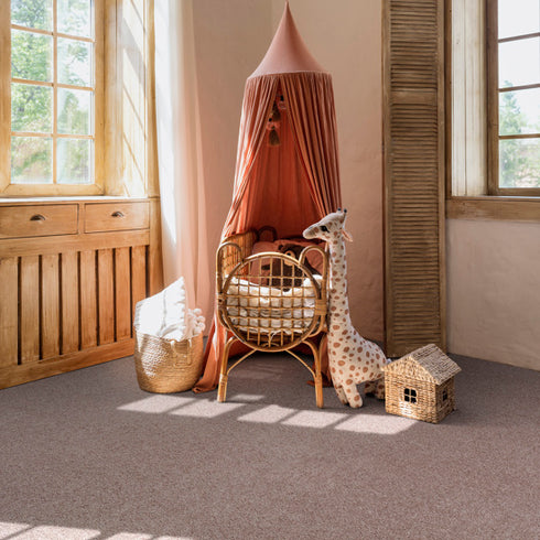 Lano Boheme carpet in beige with pink undertones, laid in a bright room with large windows, creating a warm and elegant ambiance.