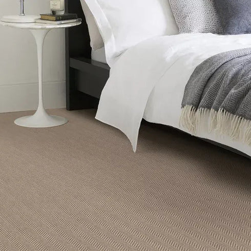 Alternative Flooring's Wool Iconic Herringbone in Pacino, set in a modern bedroom, with closeup of the herringbone's details running along the carpet.