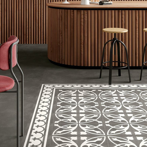 A contemporary commercial lounge space showcasing Invictus LVT Victorian Treasure Charcoal flooring, with its bold contrast and ornate vintage design enhancing the ambiance.