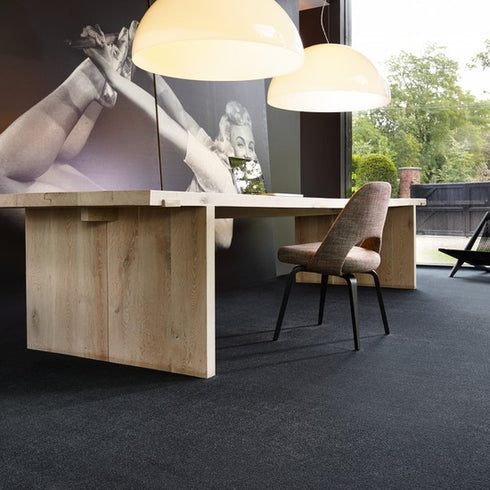 Lano Dream carpet in Ebony, a deep grey-black shade, enhancing a modern upscale home office with sophistication and refined style.