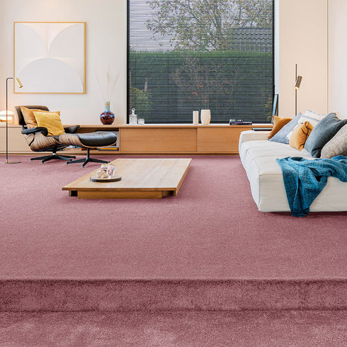 Sedna® Kai carpet in a purple-pink ruby, blending seamlessly into a contemporary living room.