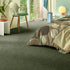 Sedna® Kai carpet in a deep olive green, adding a subtle pop of color to a sophisticated bedroom.
