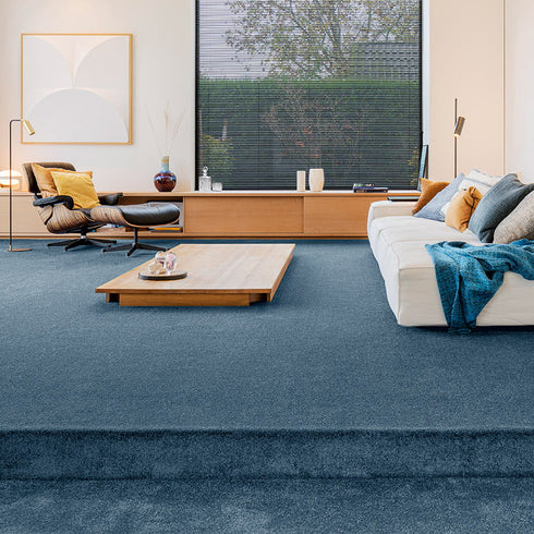Sedna® Kai carpet in a mid-tone warm blue, offering a neutral yet inviting touch to any interior space.