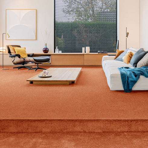 Sedna® Kai carpet in a warm sunburst orange with subtle sand and gold undertones, adding a radiant yet sophisticated touch to any space.