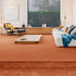 Sedna® Kai carpet in a warm sunburst orange with subtle sand and gold undertones, adding a radiant yet sophisticated touch to any space.