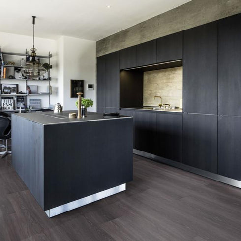 Kährs Calder luxury vinyl flooring showcasing a dark, rich wood tone with pronounced grain details, ideal for adding depth and elegance to any space.