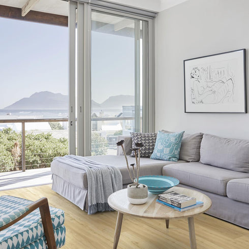 Kährs Oulanka luxury vinyl flooring presenting a warm, honey-toned oak appearance with delicate knots and grains, perfect for creating a cozy atmosphere.