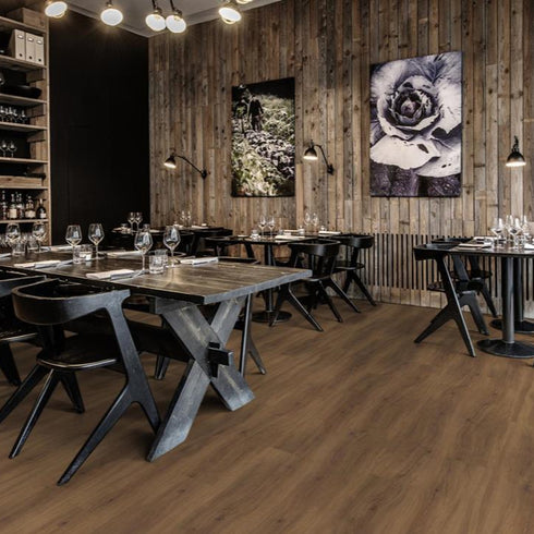 Kährs Redwood luxury vinyl flooring displaying a reddish-brown hue with intricate wood grain patterns, offering a bold and rustic charm.