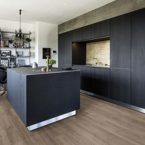 Kährs Sarek luxury vinyl flooring featuring a medium brown oak finish with balanced grain textures, suitable for versatile interior designs.