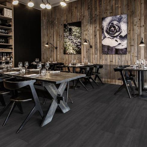 Kährs Schwarzwald luxury vinyl flooring showcasing a deep charcoal tone with subtle wood grain accents, adding a touch of modern sophistication.