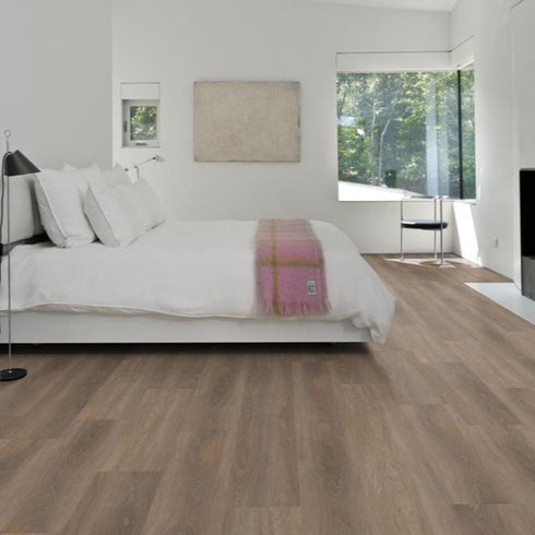 Kährs Tiveden luxury vinyl flooring presenting a cool grey oak finish with fine grain details, ideal for contemporary minimalist spaces.