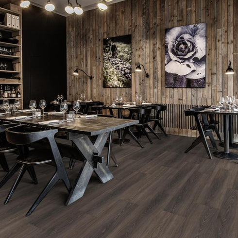 Kährs Tongass luxury vinyl flooring displaying a rich walnut tone with dynamic grain patterns, perfect for creating a warm and inviting environment.