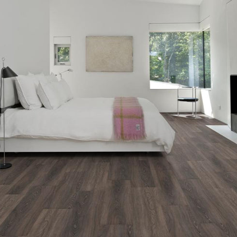 Kährs Tongass luxury vinyl flooring displaying a rich walnut tone with dynamic grain patterns, perfect for creating a warm and inviting environment.