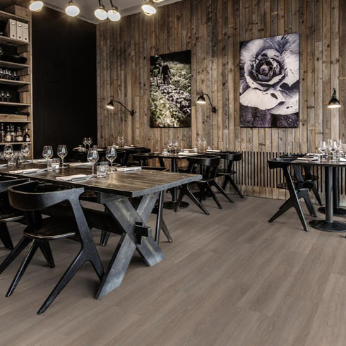 Kährs Whinfell luxury vinyl flooring showcasing a natural oak finish with gentle grain patterns, providing a classic and timeless look.