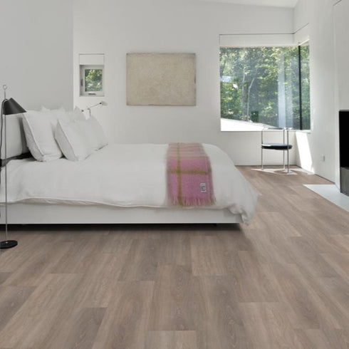 Kährs Whinfell luxury vinyl flooring showcasing a natural oak finish with gentle grain patterns, providing a classic and timeless look.