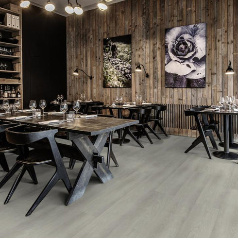 Kährs Yukon luxury vinyl flooring presenting a light grey wood tone with understated grain details, suitable for modern and industrial-style interiors.
