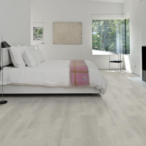 Kährs Yukon luxury vinyl flooring presenting a light grey wood tone with understated grain details, suitable for modern and industrial-style interiors.