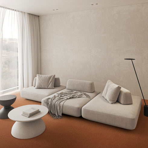 Lano Lior carpet in rust, enhancing a minimalist living room with warm tones and a sleek, understated design.