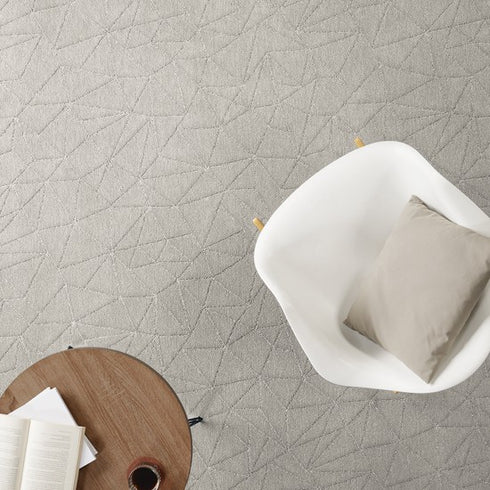 Bird’s-eye view of Lano Loft Life Grand carpet in off-white, enhancing a minimalist room with a clean, modern, and serene atmosphere.