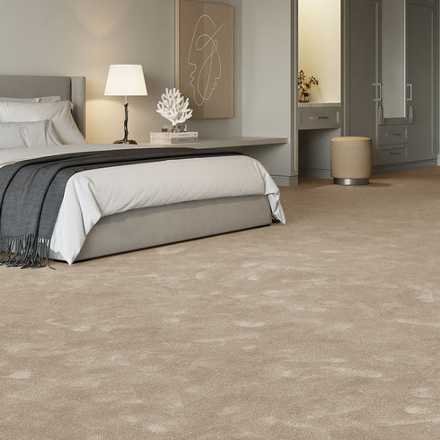 Rich warm beige iSENSE® Obsession carpet in a bedroom, offering a deeper, more sophisticated tone for a cosy and elegant space.