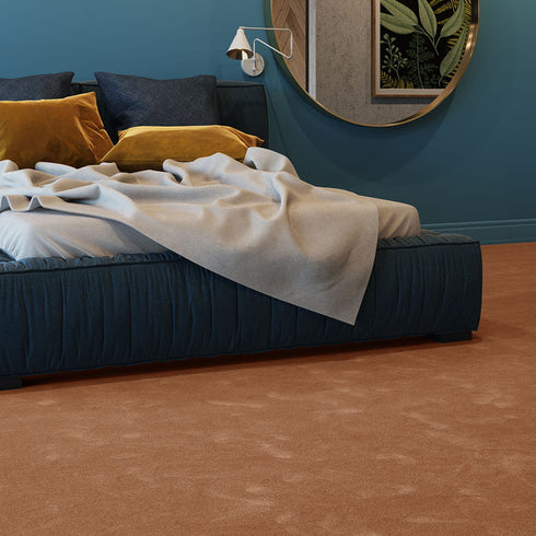 Warm sand-toned iSENSE® Obsession carpet in a bedroom, offering a natural and inviting aesthetic with a soft, luxurious feel.