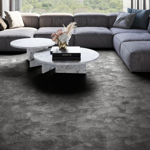 Deep charcoal grey iSENSE® Obsession carpet in a living room, adding a rich and sophisticated touch with its plush, luxurious texture.