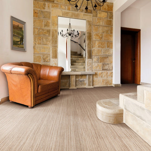 Elegant living room featuring Riviera Home Sherwood wool carpet in a soft neutral tone. The sophisticated loop pile texture adds warmth and luxury, complementing the modern furnishings, minimalist décor, and serene color palette.