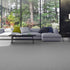 Lano Romance carpet in Silver 1 (a grey), beautifully laid in a modern living room, featuring a sleek sofa and full-length windows that offer a stunning view of nature, enhancing the serene and elegant ambiance.