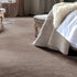 iSENSE® Surprise carpet in a warm beige with subtle brown undertones, creating a cozy and inviting atmosphere in a bedroom setting.