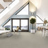 Lano Sweet Elegance carpet in Flax (beige), beautifully fitted in a spacious lofted apartment with large windows overlooking the water, enhancing the serene and sophisticated ambiance.