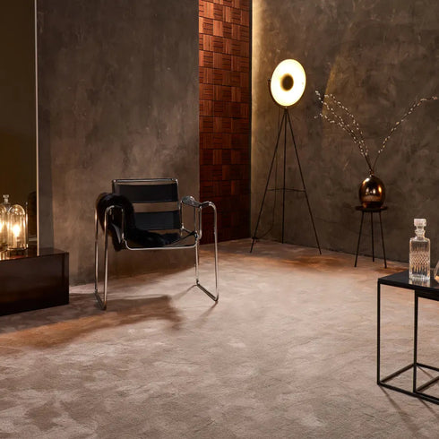 ITC Monza carpet in brown, adding warmth and elegance to an upscale vintage living room with a sophisticated and timeless design.