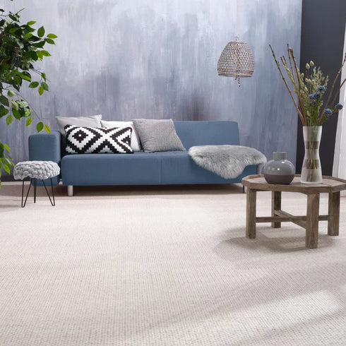 ITC Elba carpet in beige, adding natural warmth and texture to a simple modern living room with a minimalist design.