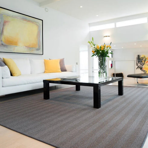 ITC Habanna as a rug, in 9318, a 100% sisal prduct. Set in a modern living room with neutral tones, and a splash of yellow.