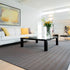 ITC Habanna as a rug, in 9318, a 100% sisal prduct. Set in a modern living room with neutral tones, and a splash of yellow.
