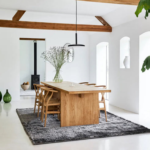 ITC Singapore rug in Cement Grey, enhancing a modern dining room with its plush texture and sophisticated elegance.