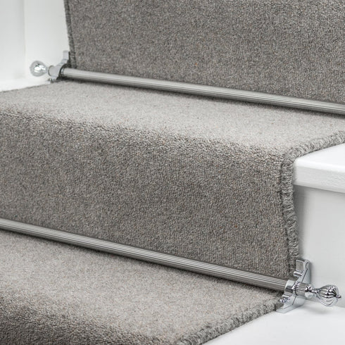 Stairrods UK Eastern Promise Cairo in chrome, seamlessly installed on a grey carpet runner, complementing the white wooden stairs with a sleek silver finish for a refined, modern look.