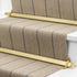 Stairrods UK Royale Louis stair rods in polished brass, elegantly installed as a runner on a staircase, adding a classic and luxurious gold-toned finish.